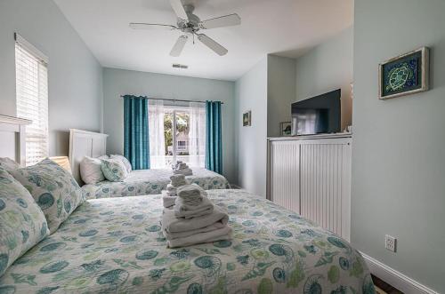 a bedroom with two beds with towels on the bed at Charming Coastal Retreat on Fripp Island - 3BR/3BA with Golf Course Views in Fripp Island