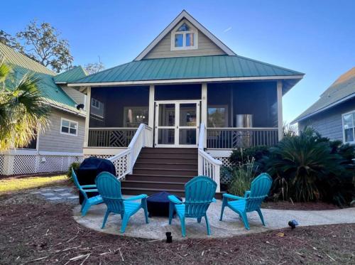 a blue house with blue chairs and a porch at Charming Coastal Retreat on Fripp Island - 3BR/3BA with Golf Course Views in Fripp Island