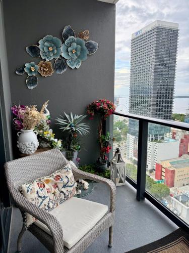 a balcony with a wicker chair and a view of a city at Miami Luxe Escape Best High Waterfront Views, City Lights, Pool, Spa Amazing location in Miami