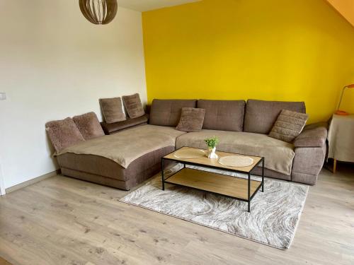 a living room with a couch and a table at Apartament przy Parku Wodzickich - blisko Term, Turbacz, KGP in Poręba Wielka