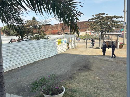 a group of people walking around a fence at Apartment with WiFi Downtown Cali in Cali