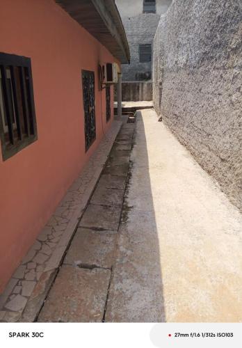 an empty alley with a building and a wall at Résidence le HAMEAU de BITENG in Yaoundé