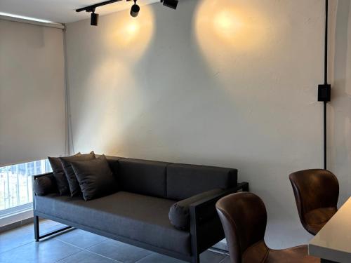 a living room with a couch against a white wall at Apartment with WiFi Downtown Cali in Cali