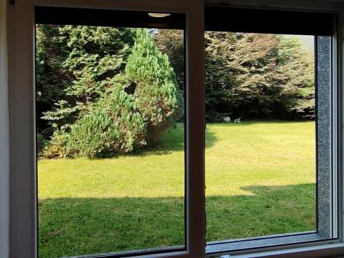 a window with a view of a field of grass at L'idea di una Notte in San Maurizio dʼOpaglio