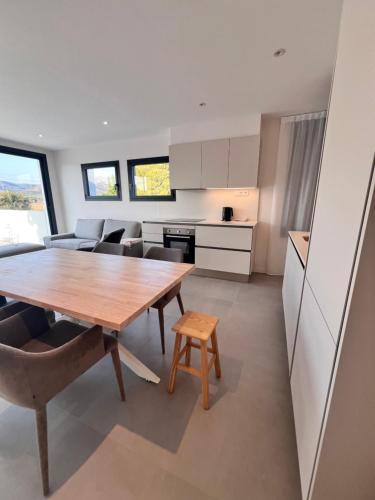a kitchen and dining room with a wooden table and chairs at Camping Joncar Mar in Roses