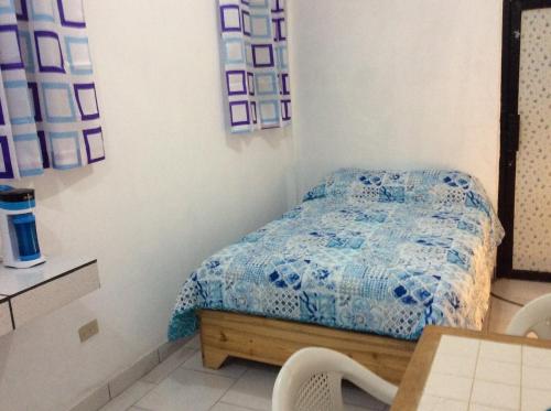 a bedroom with a bed and a table and chairs at Miami Studios DR in Santo Domingo