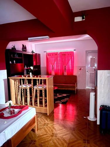 a living room with a couch and a table with red lighting at Casa BB&Djassi - Studio in Ponta do Sol