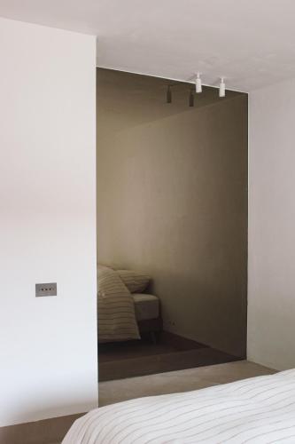 a bedroom with a bed and a wall at Villa Kint in Damme