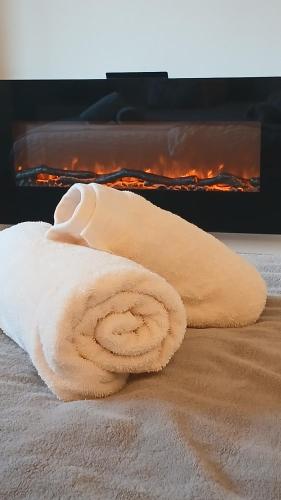 a towel sitting on a bed in front of a fireplace at Ferienwohnung Bergblick in Gallzein
