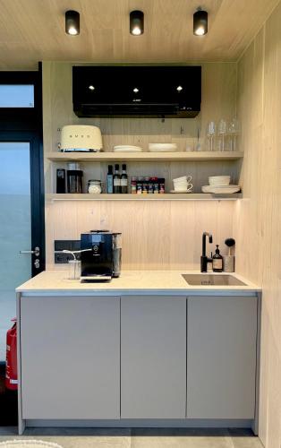 a kitchen with white cabinets and a counter top at Nest Retreat Iceland in Hella