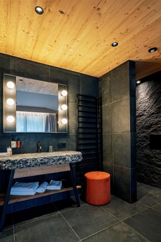 a bathroom with a sink and a mirror at La Tambra - Hotel Lodge in Santa Cristina Gherdëina