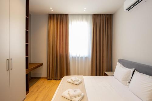 Säng eller sängar i ett rum på Infinity Apartment