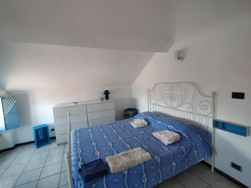a bedroom with a bed with a blue comforter at BB Dadaumpa in Novi Ligure