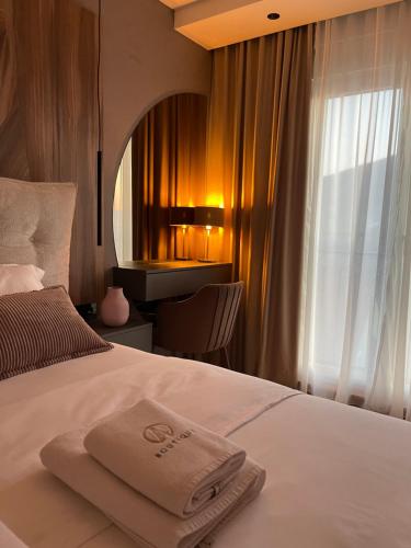 a hotel room with a bed with a towel on it at Apartman Boutique Arandjelovac in Arandjelovac