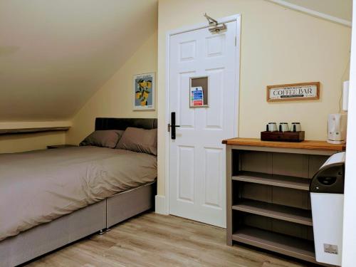 a bedroom with a bed and a white door at Castle View, 94-96 Friar Lane in Nottingham