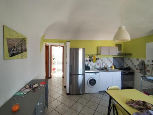 a kitchen with a refrigerator and a washing machine at BB Dadaumpa in Novi Ligure