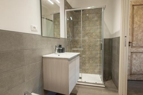 a bathroom with a sink and a shower at Alcantara Domus in Roccella Valdemone