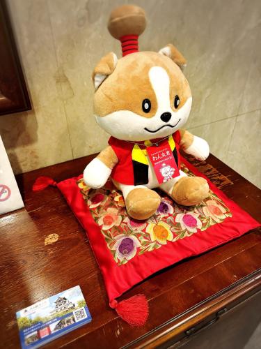 a stuffed teddy bear sitting on top of a table at Inuyama City Hotel in Inuyama
