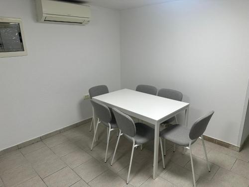 a meeting room with a white table and chairs at Apartment Dantéa - NEW 2025 in Izola