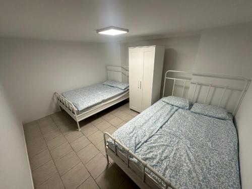 two twin beds in a room with at Apartment Dantéa - NEW 2025 in Izola