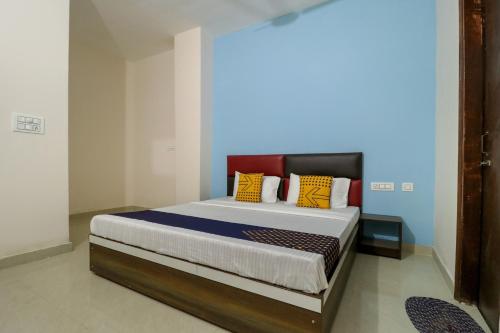 a bedroom with a large bed with colorful pillows at Hotel O kalra in Zirakpur