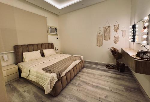 a bedroom with a large bed in a room at Modern Apartment in Jeddah