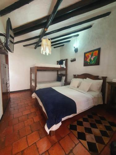 a bedroom with a large bed in a room at Hotel Quinta de Santa Ana in Tibasosa