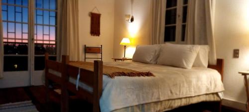a bedroom with a bed with a view of the city at Espacio 566 Hostel in La Serena