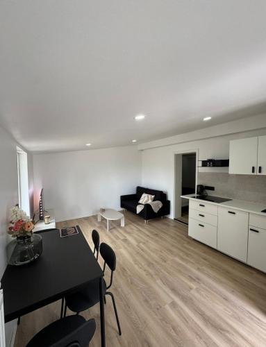 a living room with a table and a couch at Comfy House Erftstadt in Erftstadt