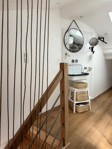 a hallway with a wooden staircase with a mirror at Casa Tassinca in Tasso