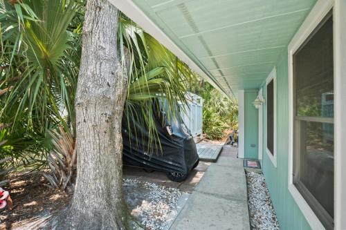 a black car parked next to a house with a tree at Distinctive Island Living - 835 Bonito Rd, Fripp Island in Fripp Island