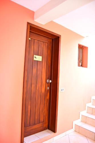 a wooden door in a room with stairs at Central Apartamento Fogo 101 in Santa Maria