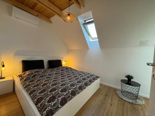 a bedroom with a large bed in a attic at Wonder Lelle - Balaton Retreat in Balatonlelle