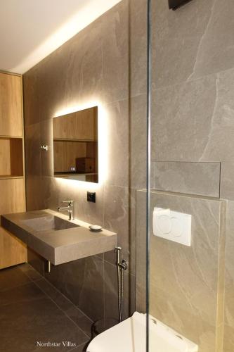 a bathroom with a sink and a toilet at Northstar Villas in Bogë
