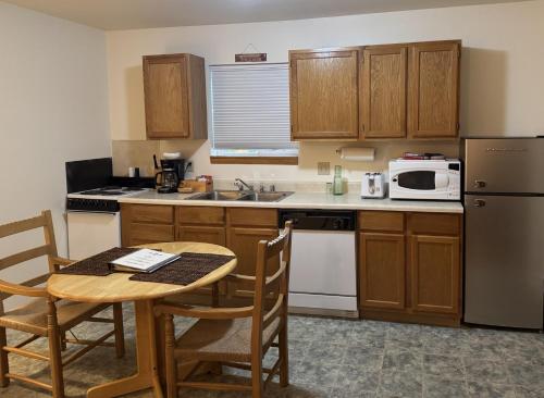 a small kitchen with a table and a microwave at Rocky Mountain Inn in Paonia