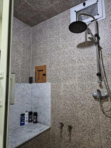 a bathroom with a shower with two cell phones at essaouira burgo in Essaouira