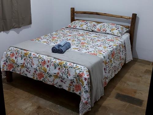 a bed with a camera sitting on top of it at Pousada Shemah em Penedo in Itatiaia