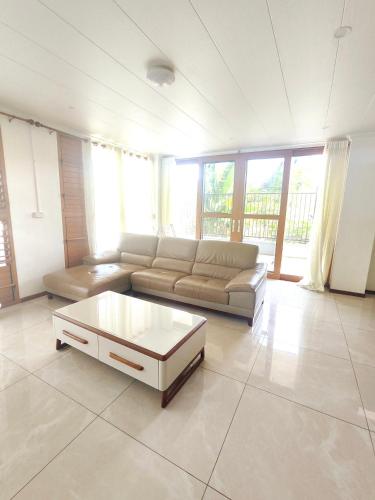 a living room with a couch and a coffee table at Alice 3-bedroom luxury apartment in Nadi
