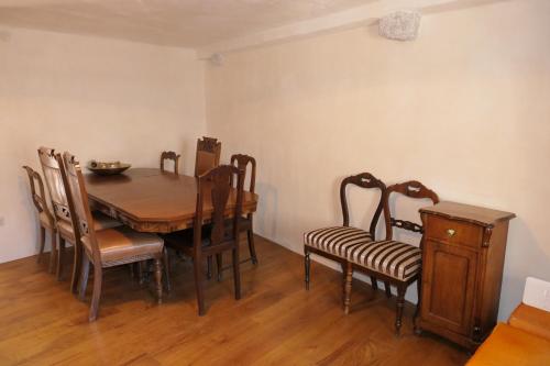 a dining room with a wooden table and chairs at Holiday house with a parking space Senj - 24830 in Senj