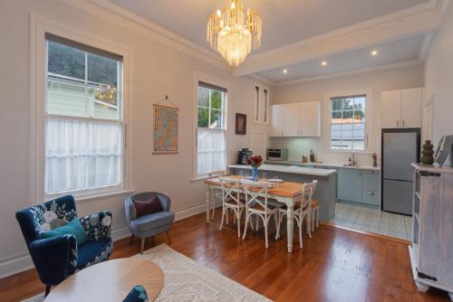 a kitchen and dining room with a table and chairs at Villa Cambria in Nelson