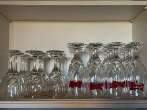 a row of wine glasses sitting on a shelf at 館山貸別荘 Arks Del Mare in Funakata