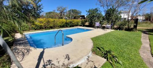 a swimming pool in the middle of a yard at Mi Casita del Paso in Paso de la Patria