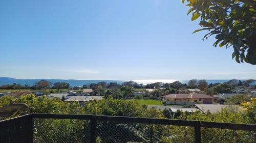 a view of a town from the balcony of a house at Seascape Hideaway Pohara in Pohara