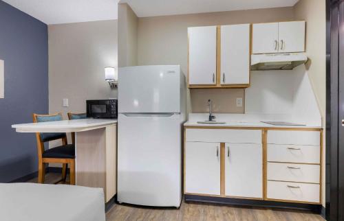 a kitchen with a white refrigerator and a table at Extended Stay America Suites - Arlington in Arlington
