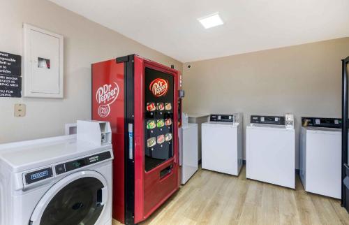 a room with a cocacola refrigerator next to three machines at Extended Stay America Suites - Arlington in Arlington