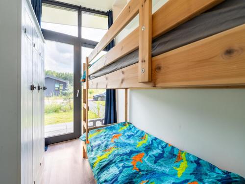 a small bedroom with a bunk bed and a window at Holiday Home near Kaag Lakes in Oud-Ade