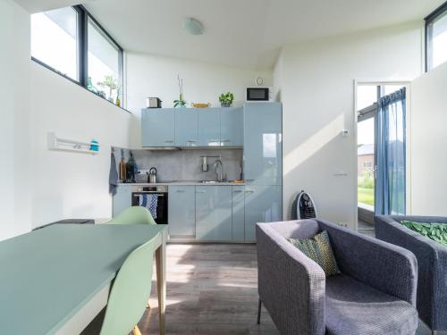 a kitchen with two chairs and a table in a room at Holiday Home near Kaag Lakes in Oud-Ade