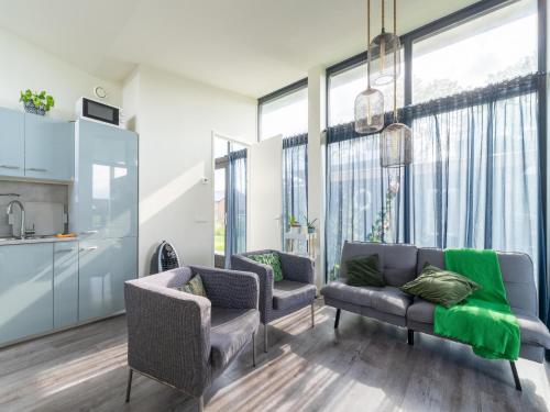 a living room with two chairs and a couch at Holiday Home near Kaag Lakes in Oud-Ade