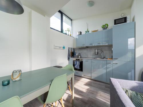 a kitchen with a table and chairs in a room at Holiday Home near Kaag Lakes in Oud-Ade