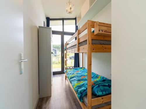 a room with a bunk bed and a hallway with a door at Holiday Home near Kaag Lakes in Oud-Ade